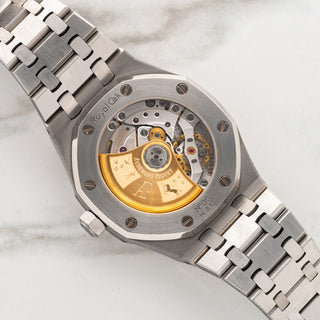 Sapphire exhibition caseback displaying the in-house AP caliber 3120 automatic movement with gold rotor on a 15450ST