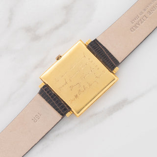 Full back view of the engraved 18k gold caseback and lizard strap of an Audemars Piguet Tank Ultra-Thin