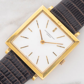 Angled shot highlighting the square 18k yellow gold case and ultra-slim profile of an Audemars Piguet dress watch