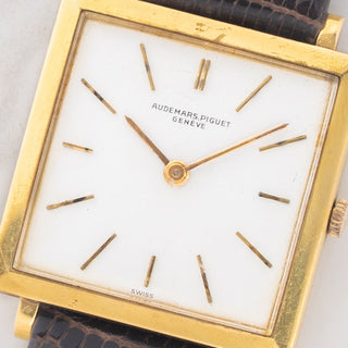 Macro close-up shot of the minimalist white dial and thin stick hour markers on an Audemars Piguet Tank Ultra-Thin