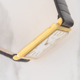 Side view displaying the slim 18k yellow gold case lines and bezel edge on an Audemars Piguet Tank