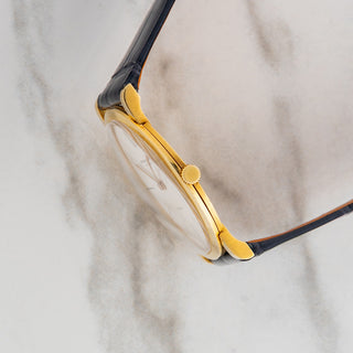 Side profile view showcasing the ultra-thin 18k yellow gold case housing the manual-wind Caliber 2003 movement on an AP 5043