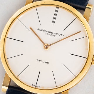 Macro close-up shot of the white dial featuring the double-signed Audemars Piguet and Bvlgari retailer signature on reference 5043