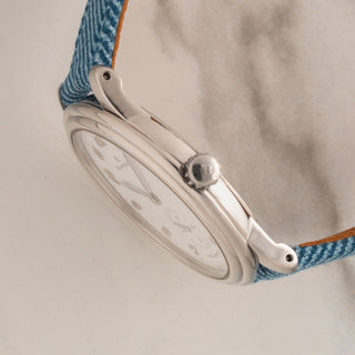 Side profile view showcasing the ultra-thin steel case design and signed winding crown of a Blancpain 7002