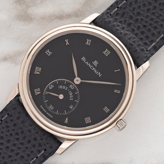 Angled shot highlighting the 18k white gold stepped bezel and grey Roman dial on an unpolished Blancpain Villeret Jubilee