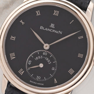 Macro close-up shot of the slate grey dial, white gold Roman numeral hour markers, and 1693-1993 sub-seconds register on a Blancpain 7001