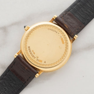18k gold caseback view showing the Chaumet stamp, serial number, and gold hallmarks on an unpolished Breguet 3210BA