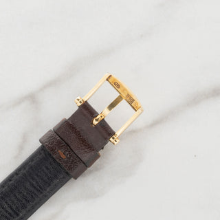 Underside view displaying the gold hallmarks on an authentic vintage 18k gold Breguet strap buckle