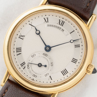 Macro close-up of the hand-turned guilloche dial, blued Breguet hands, and small seconds subdial on a Chaumet-era Breguet Classique