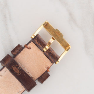 Underside view showing the gold hallmarks and double C design on an authentic vintage Cartier strap buckle