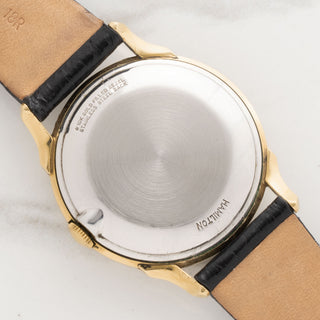 The clean stainless steel caseback and gold filled bezel markings of a 1956 vintage Hamilton Cross Country