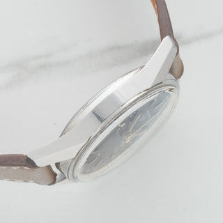 Side profile view displaying the thick, razor-sharp factory case bevels on an unpolished 1963 Heuer Carrera