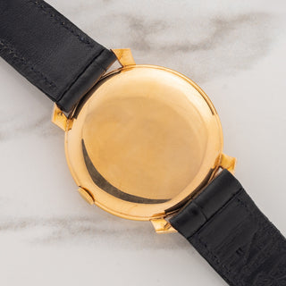 The solid 18k pink gold caseback displaying sharp factory finishes and crisp hallmarks on an IWC 521