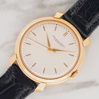 Angled shot highlighting the distinct unpolished shark fin lug shape and 18k pink gold case of an IWC reference 521