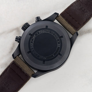 The solid matte black Ceratanium caseback with limited edition engravings on an IWC Pilot Chronograph Tribute to 3705