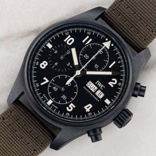 Angled shot highlighting the 41mm matte black Ceratanium case, chronograph pushers, and black dial on an IWC Tribute to 3705