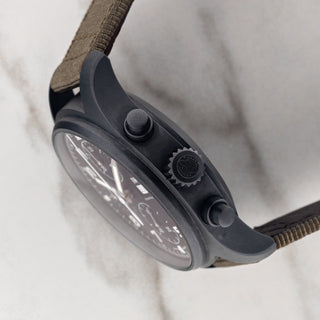 Side profile view showcasing the matte black Ceratanium case architecture, crown, and pushers on an IWC Tribute to 3705