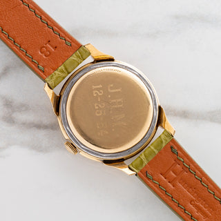 The 10k gold-filled caseback with vintage presentation engraving on a 1950s LeCoultre Powermatic bumper automatic watch