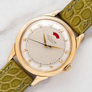 Angled shot highlighting the 10k gold-filled case, fancy lugs, and power reserve indicator on a 1950s LeCoultre Powermatic