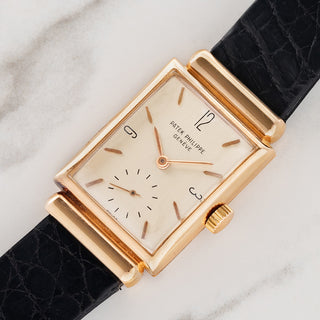 Angled shot highlighting the 18k rose gold hooded lug architecture and rectangular case on a Patek Philippe 1532R