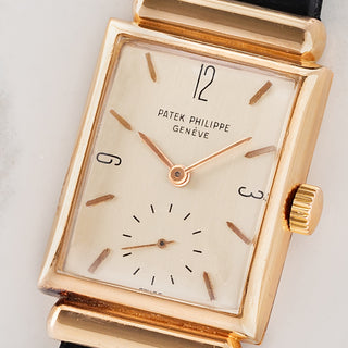 Macro close-up shot of the brushed silver dial, raised enamel signature, enamel Arabic numerals at 3-9-12, and small seconds register on a Patek Philippe 1532R