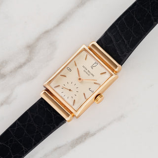 1940s Patek Philippe reference 1532R in 18k rose gold with hooded lugs and brushed silver enamel dial on a black alligator strap at Collectors Corner NY