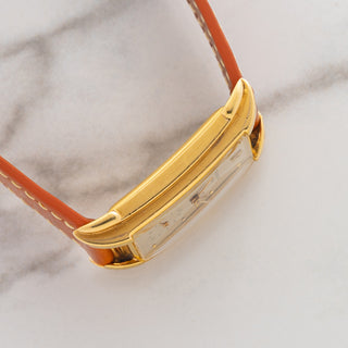 Side profile view displaying the pronounced case curvature and worked lug design on a 1950s Patek Philippe Ref 2417J