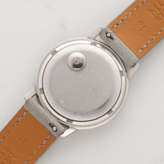 The distinctive white gold backwinding caseback showing the crisp hallmark and caliber 1-350 crown layout on a Patek 3569