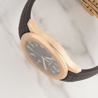 side profile showing the clean lines and satin-brushed bezel edges of a luxury Patek Philippe Aquanaut watch