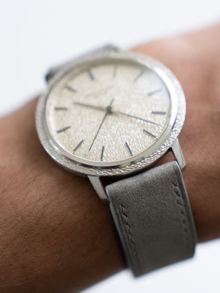 Angled wrist shot showing the light reflection on the hammered bezel and dial of the vintage Patek Philippe 3569