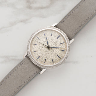 Vintage 1970 Patek Philippe Calatrava reference 3569 in white gold with a hammered finish dial and grey suede strap at Collectors Corner New York