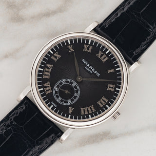 Angled shot highlighting the platinum officer style case and black guilloché dial of a Patek Philippe Calatrava 5022P