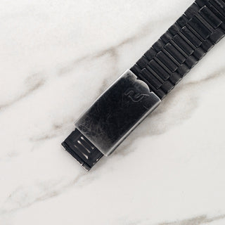 Close-up view of the black PVD folding clasp and integrated bracelet on a vintage Porsche Design Orfina chronograph