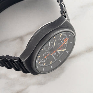 Side profile view displaying the matte PVD case finish and hooded lug design on a Porsche Design Orfina 7177 military watch