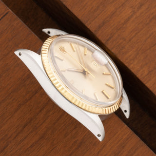 Angled top perspective showcasing the acrylic crystal and warm brown tropical dial on a vintage Datejust