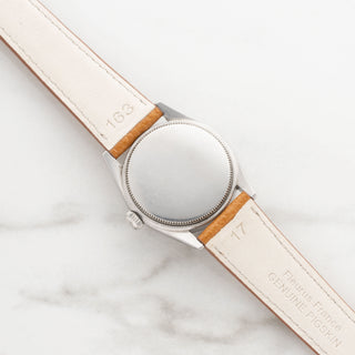he smooth stainless steel caseback and genuine leather strap underside of a vintage Rolex Oysterdate 6466