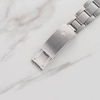 Close-up view of the brushed stainless steel folding clasp and Rolex coronet on a 7835 folded-link bracelet