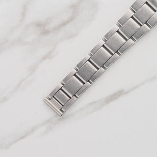 Top view displaying the stainless steel folded-link Oyster bracelet construction on a Rolex Oyster Precision