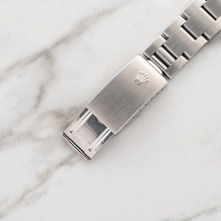 Close-up view of the brushed stainless steel folding clasp with Rolex coronet on an Oyster bracelet