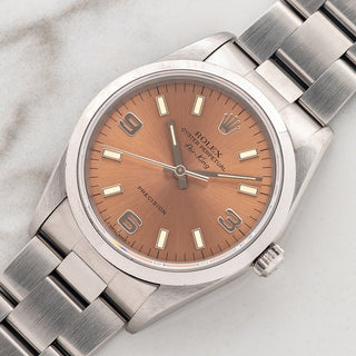 Angled shot highlighting the 34mm stainless steel case, smooth bezel, and salmon Explorer dial on a Rolex Air-King 14000