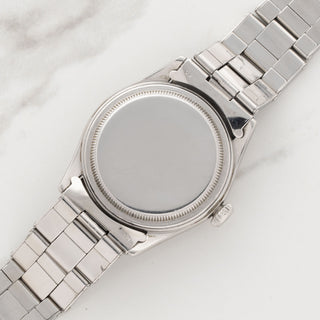 The clean, smooth stainless steel caseback of a vintage Rolex Air King reference 4499
