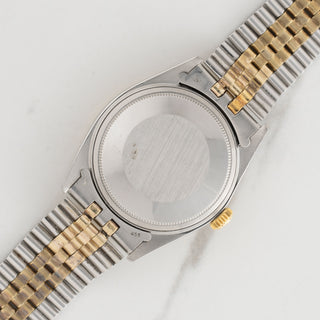 The clean stainless steel Oyster caseback and gold winding crown on a vintage two tone Rolex Datejust