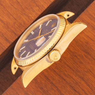 Angled top perspective showcasing the unpolished case lines, deep hallmarks, and signed crown on a Rolex 16018