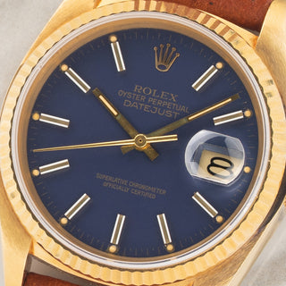 Macro close-up shot of the rare matte blue dial, gold stick markers, and matching tritium lume plots on a Rolex 16018
