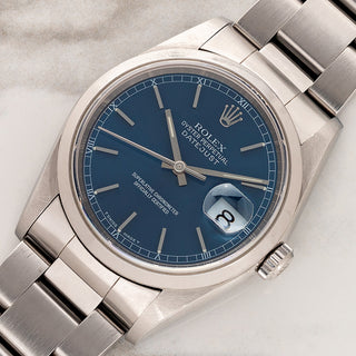 Angled shot highlighting the smooth stainless steel bezel, sharp lugs, and vibrant blue dial of a Rolex Datejust 16200