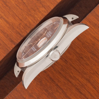 Angled top perspective showcasing the sharp case lines, sapphire crystal, and winding crown on a blue dial Rolex 16200