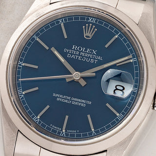 Macro close-up of the pristine blue sunburst dial, Roman numeral minute track, and quickset date on a Rolex 16200