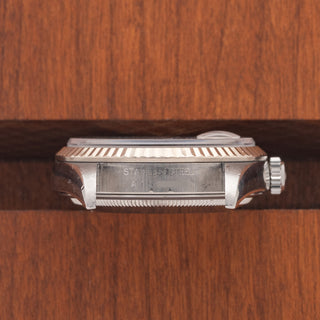 Horizontal case profile showing the 18k white gold fluted bezel and clear 16234 reference number engraving between the lugs