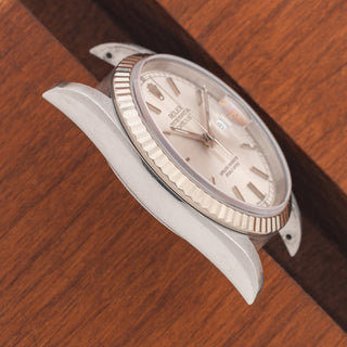 Angled top view highlighting the thick lug proportions and silver sunburst dial on a Rolex Datejust 16234