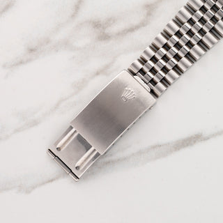 Close-up view of the stainless steel folding clasp signed with the Rolex coronet on a Jubilee bracelet